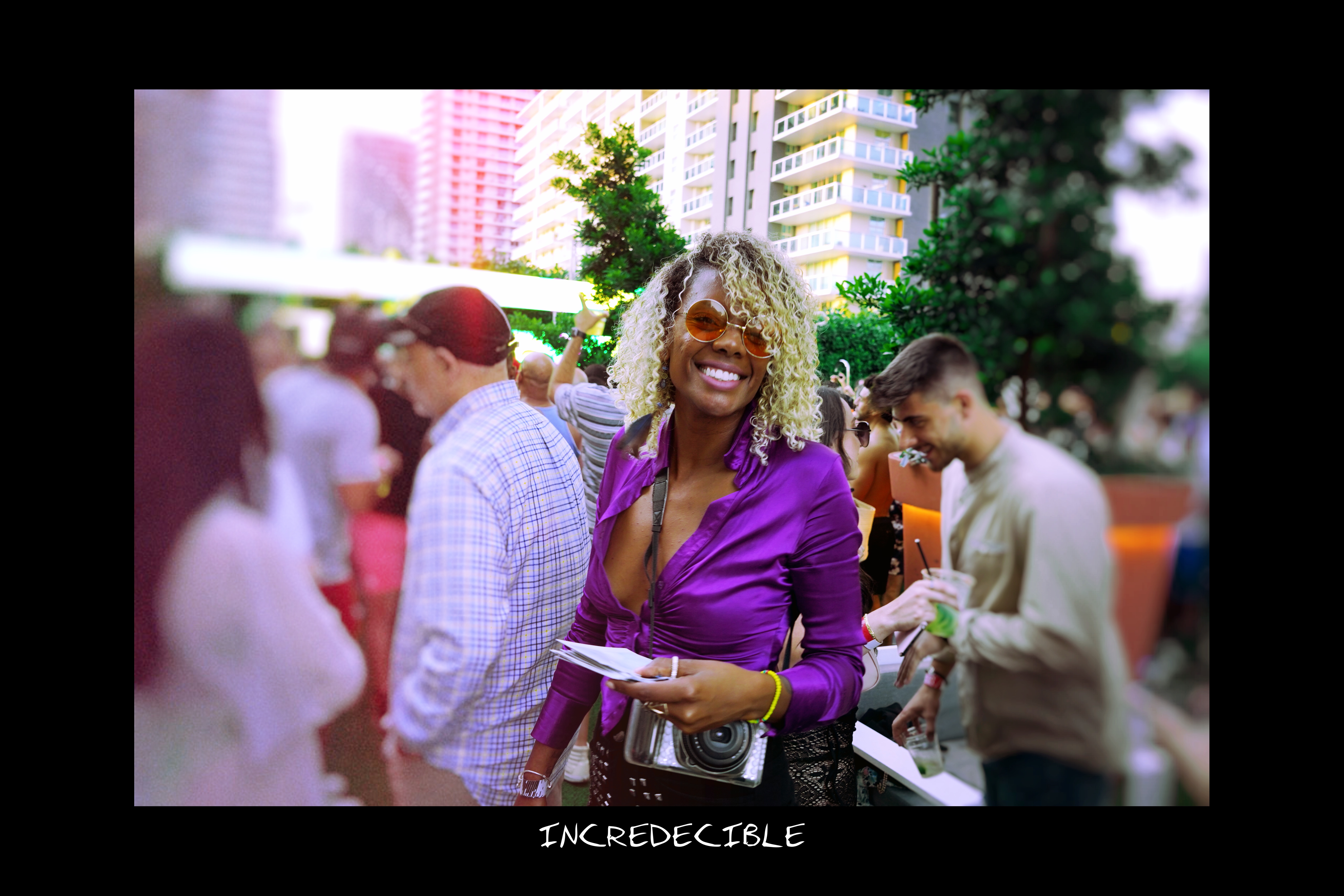 Guests holding instant photos at an event in Miami