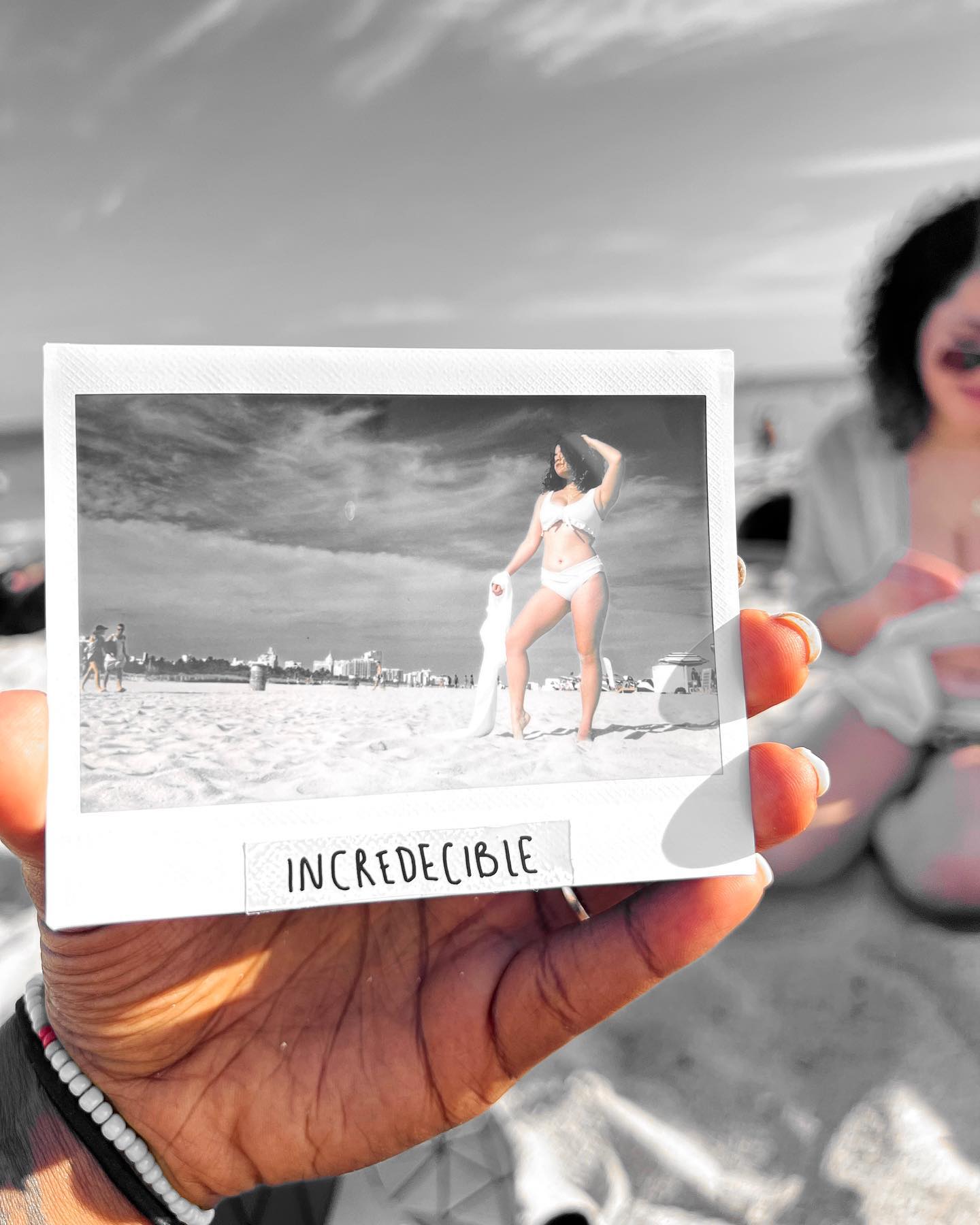 Instant photo print held in hand with the Incredecible frame